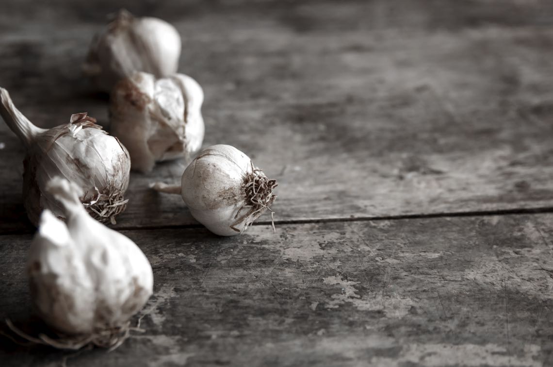 bigstock-Garlic-On-A-Wooden-Table-61315409
